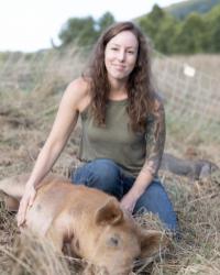 Lauren Lovejoy with adorable piglet on a farm